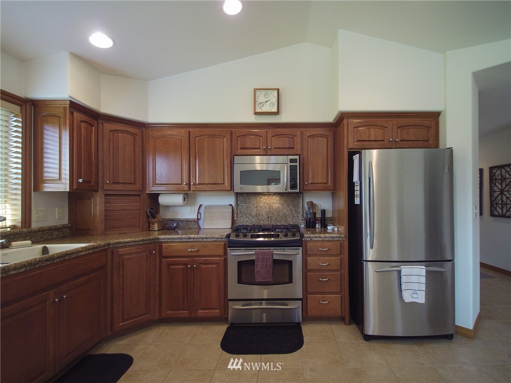247 Jake Way Sequim, WA 98382 - Photo 8 of 40 a kitchen with a sink and stainless steel appliances