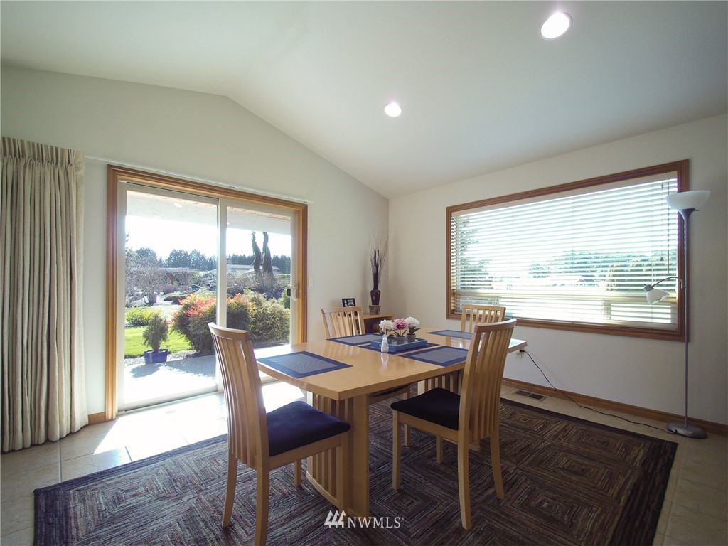 247 Jake Way Sequim, WA 98382 - Photo 10 of 40 a view of a dining room with furniture large windows and wooden floor