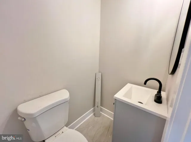 a white toilet sitting next to a sink