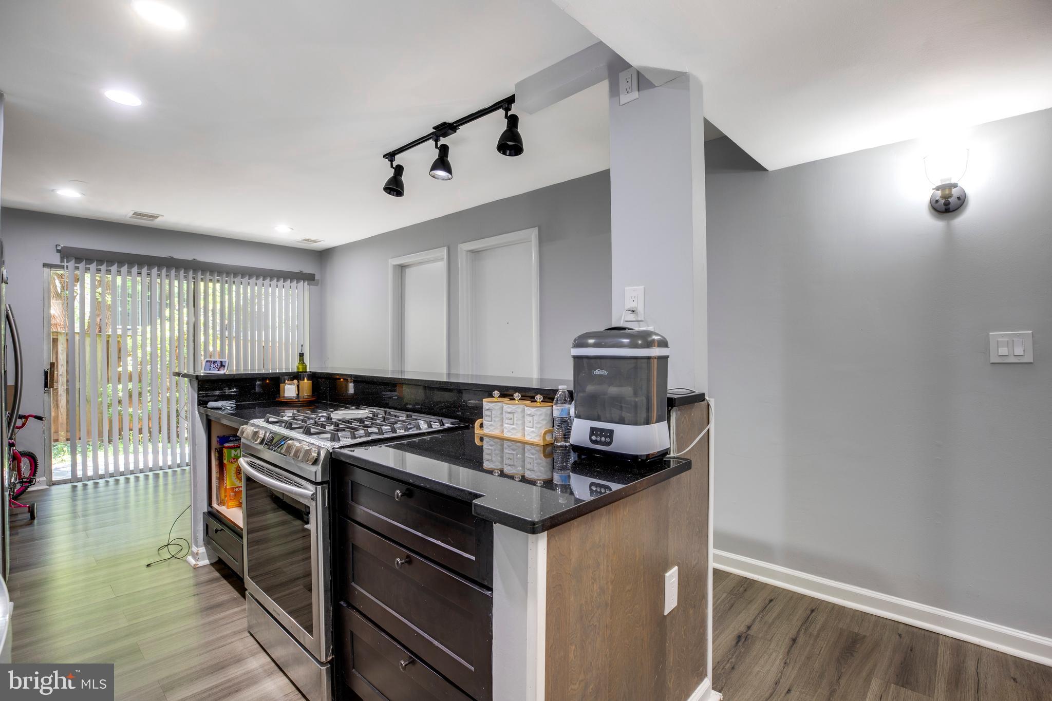 3382 Hewitt Avenue, Unit 102 Silver Spring, MD 20906 - Photo 6 of 22 a kitchen that has a sink and a stove