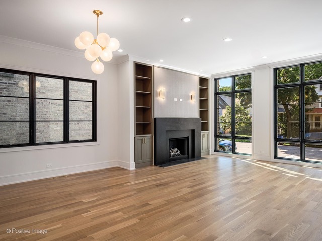 2214 West Oakdale Avenue Chicago, IL 60618 - Photo 2 of 15 a view of an empty room with wooden floor and a window