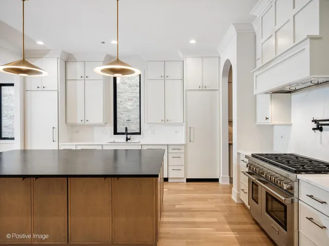 a kitchen with stainless steel appliances granite countertop a stove and a refrigerator