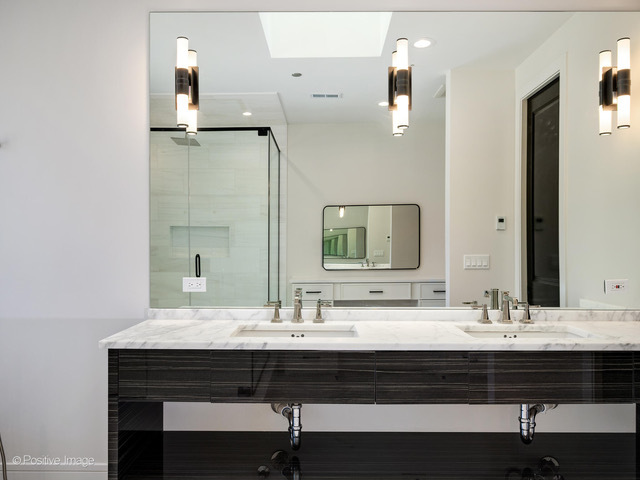 2214 West Oakdale Avenue Chicago, IL 60618 - Photo 8 of 15 a bathroom with a sink and a mirror