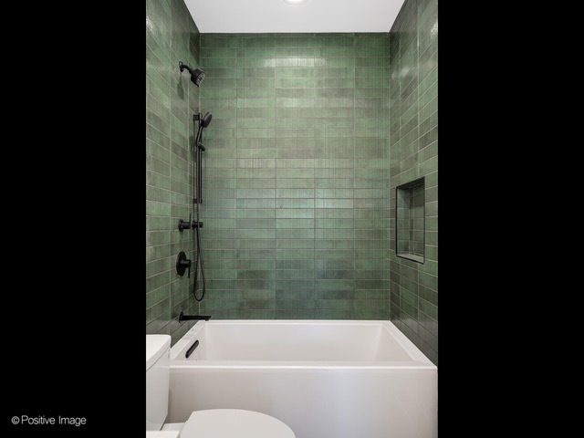 2214 West Oakdale Avenue Chicago, IL 60618 - Photo 10 of 15 a bathroom with a shower and bathtub
