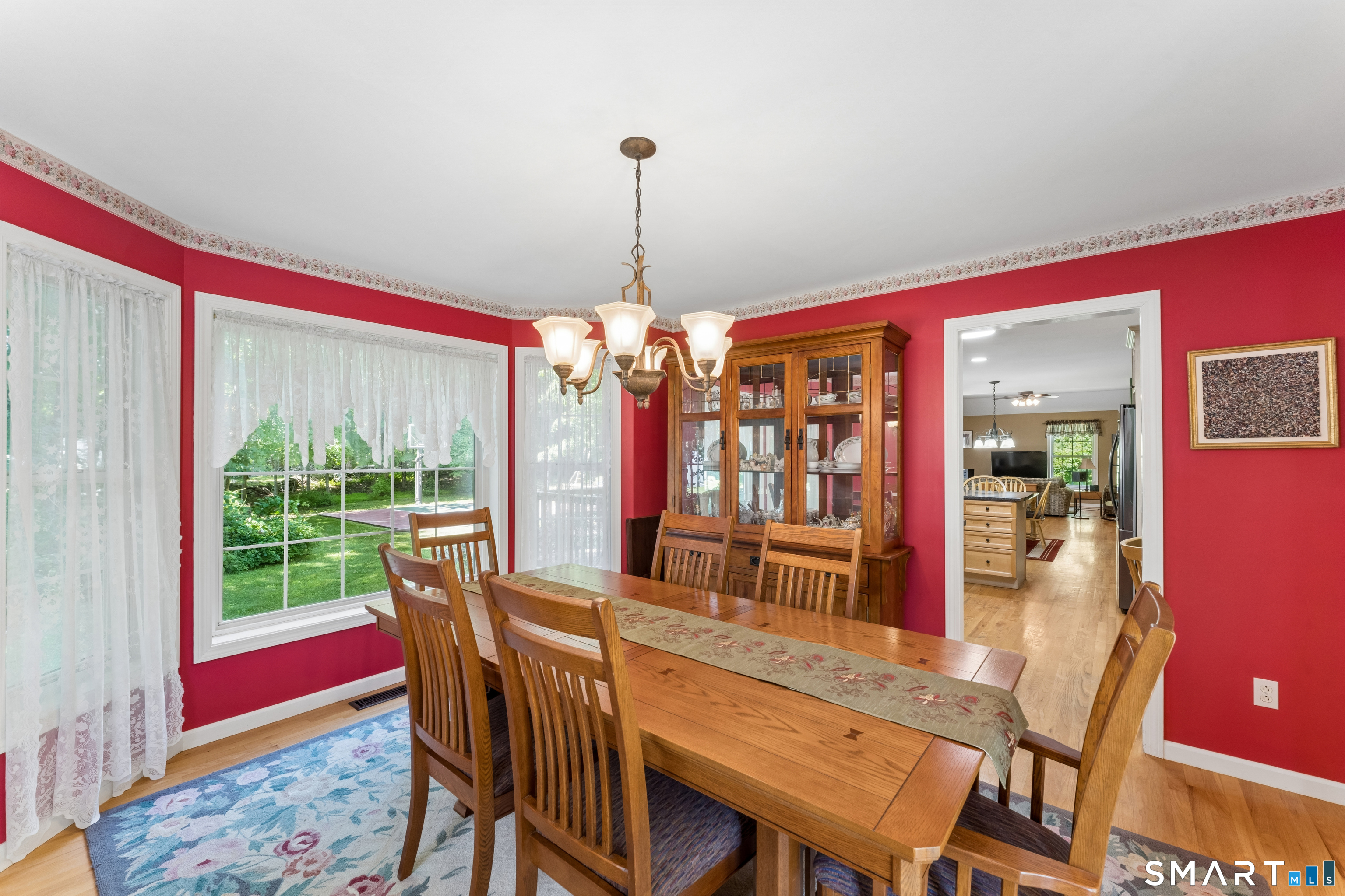 10 Ferris Road Newtown, CT 06470 - Photo 11 of 40 a dining room with furniture a chandelier and wooden floor