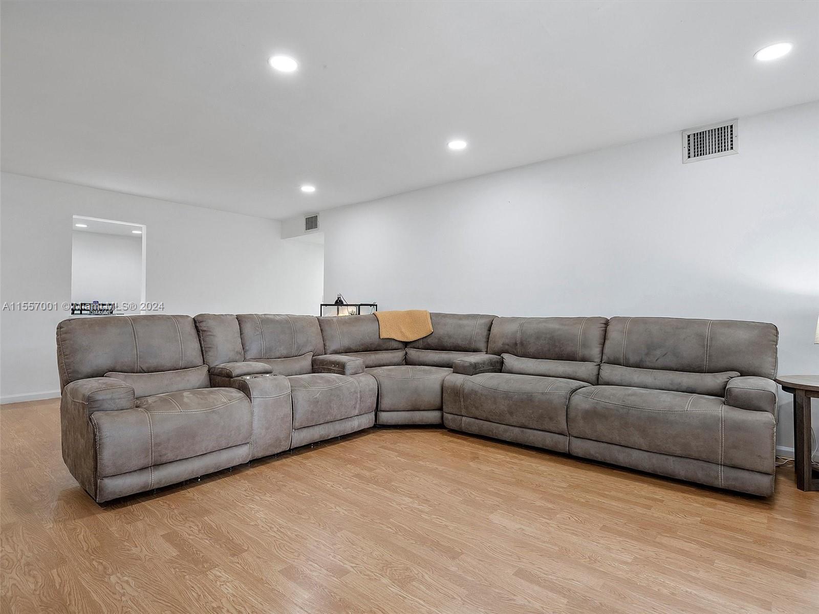 a living room with a couch and a wooden floor