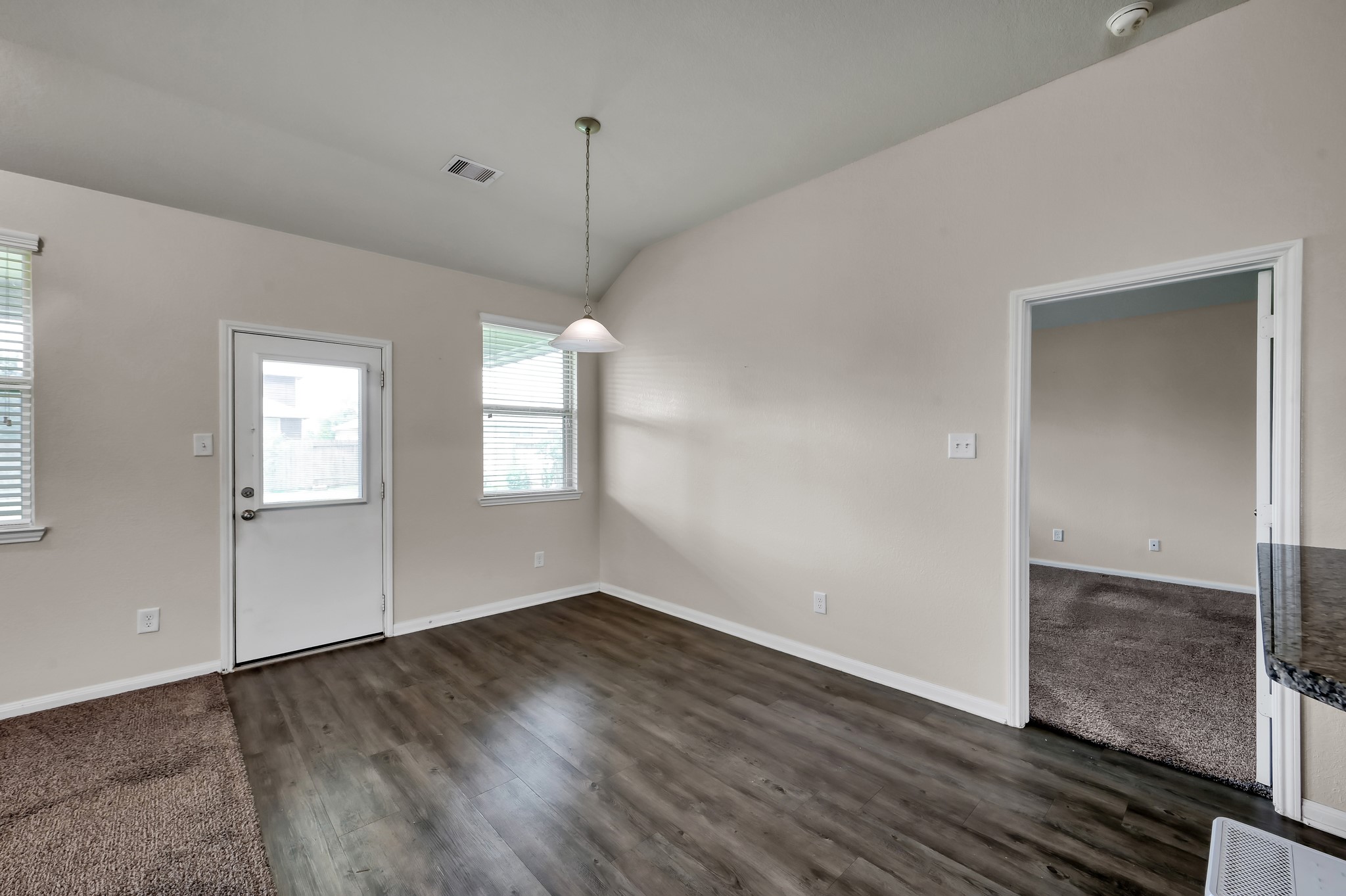 3532 Korina Way Conroe, TX 77306 - Photo 19 of 34 an empty room with wooden floor and windows