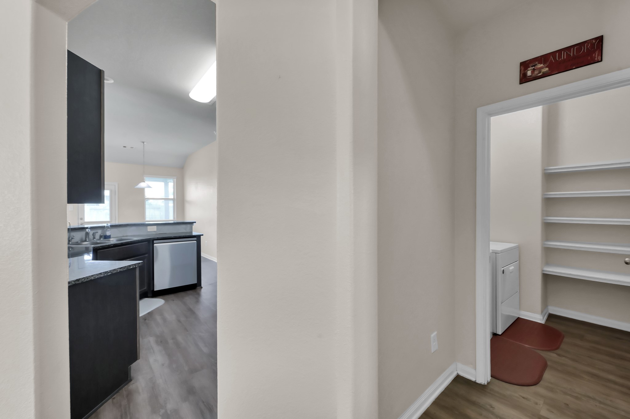3532 Korina Way Conroe, TX 77306 - Photo 5 of 34 a view of a kitchen with a sink and dishwasher stove top oven with wooden floor