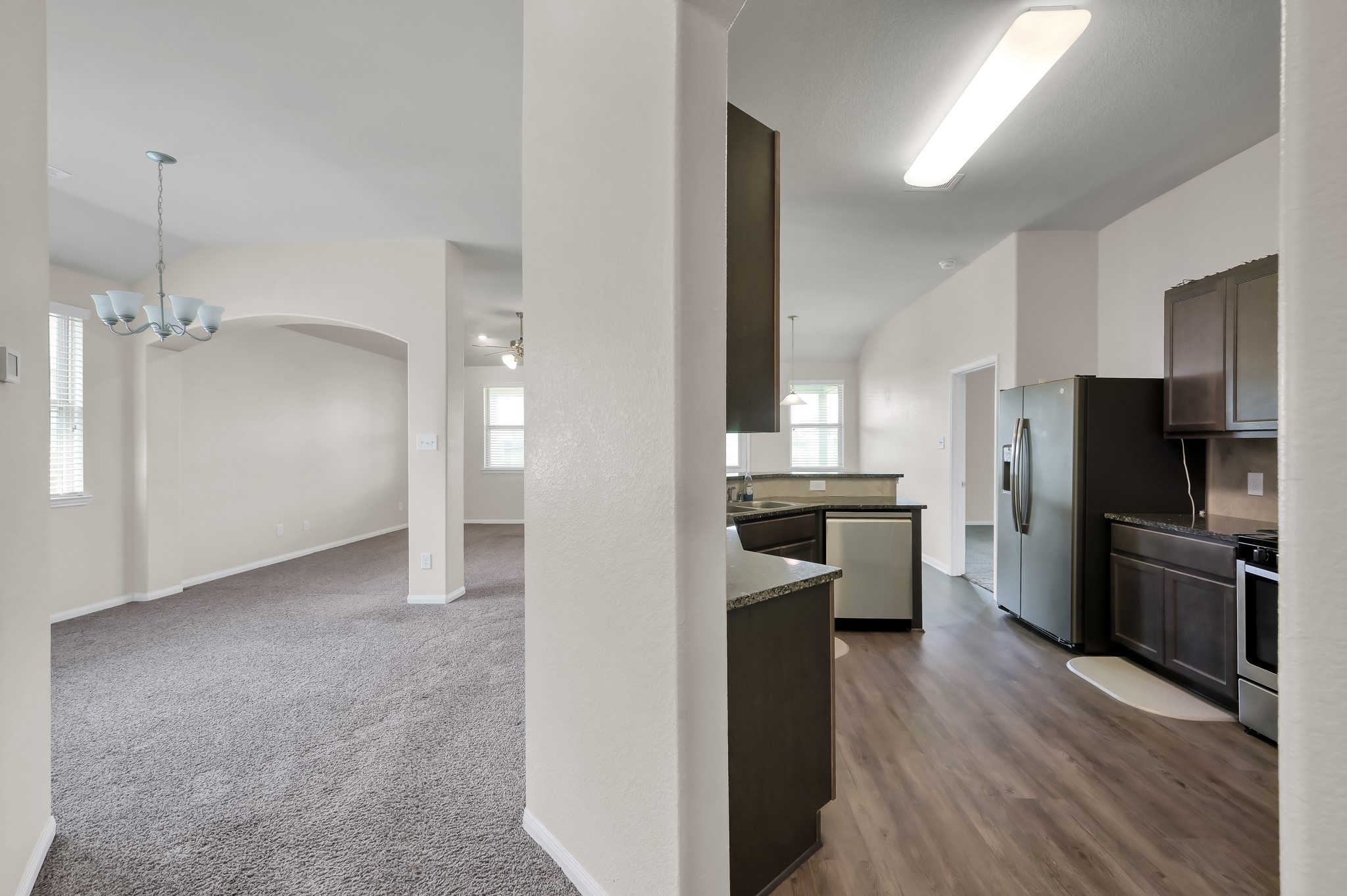 3532 Korina Way Conroe, TX 77306 - Photo 7 of 34 a large kitchen with a refrigerator a stove top oven a sink and dishwasher