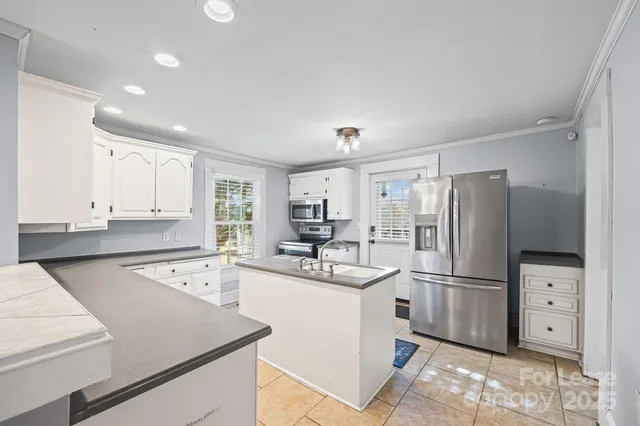 a kitchen with a sink a stove and refrigerator