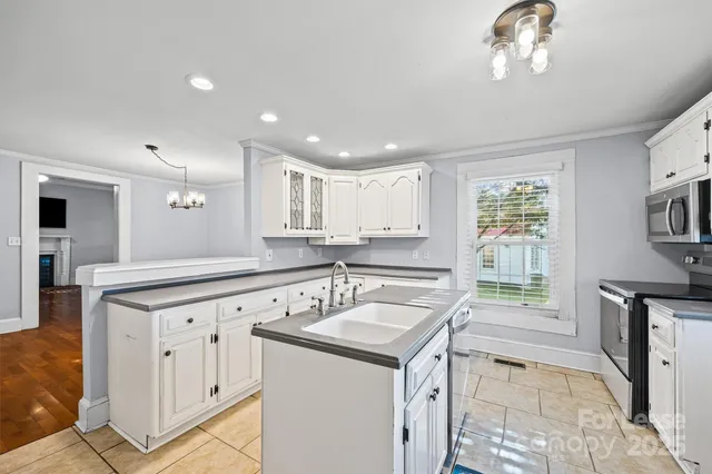 a kitchen with a sink stove and cabinets