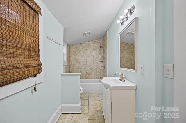 a bathroom with a sink mirror and toilet