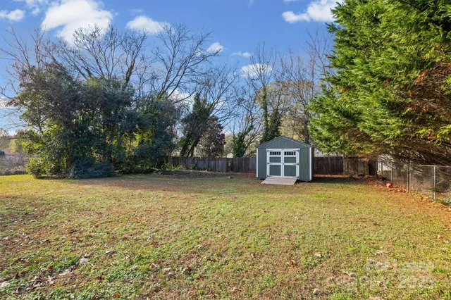 a view of a house with wooden fence