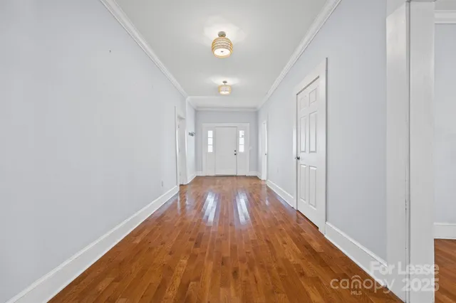 a view of hallway with wooden floor