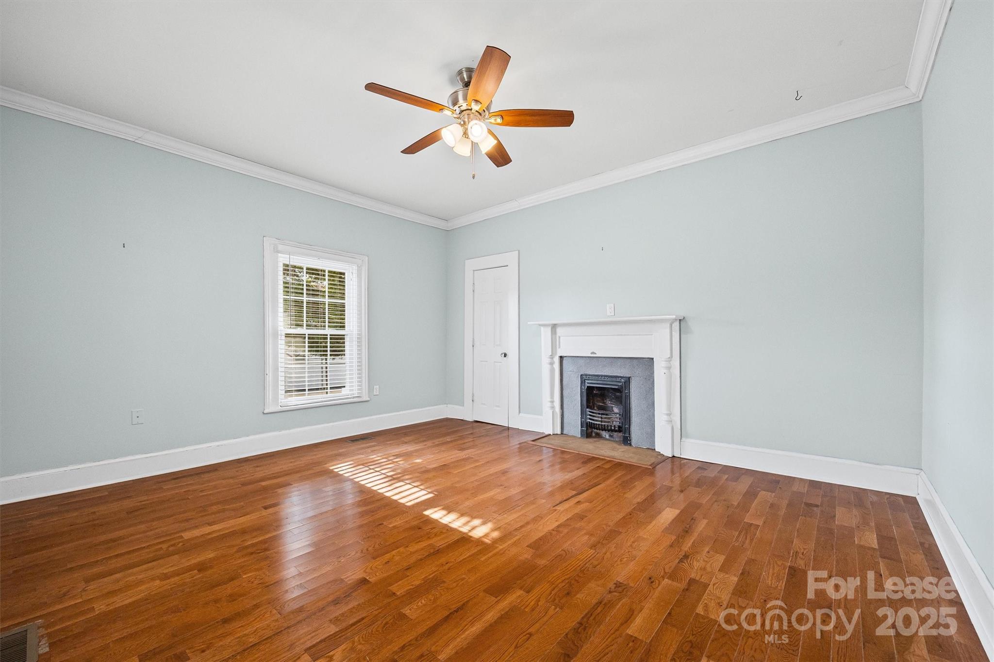 512 Banks Street Fort Mill, SC 29715 - Photo 6 of 30 a view of empty room with wooden floor and fireplace