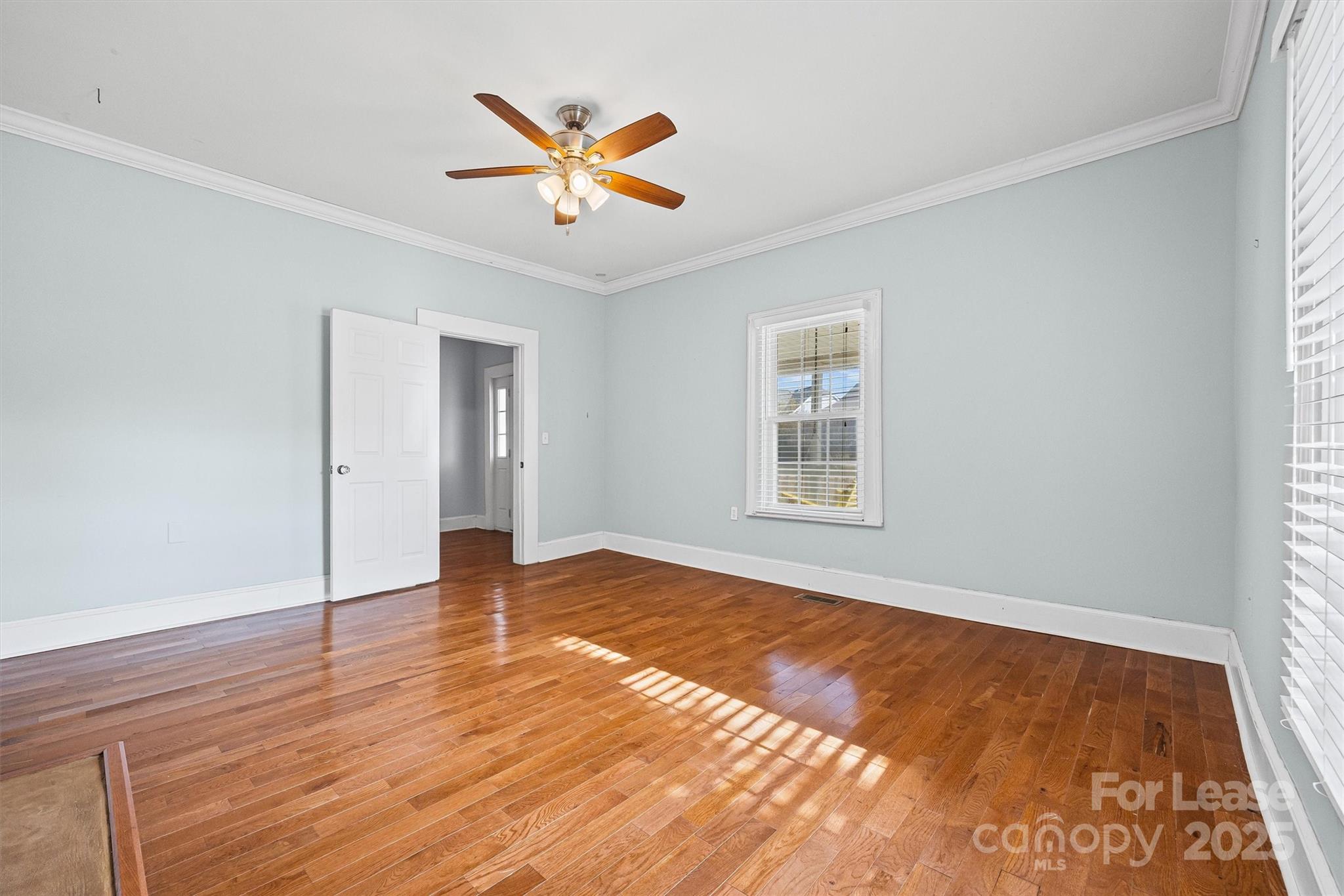 512 Banks Street Fort Mill, SC 29715 - Photo 7 of 30 a view of empty room with wooden floor and fan