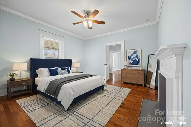 a bedroom with a bed and a ceiling fan