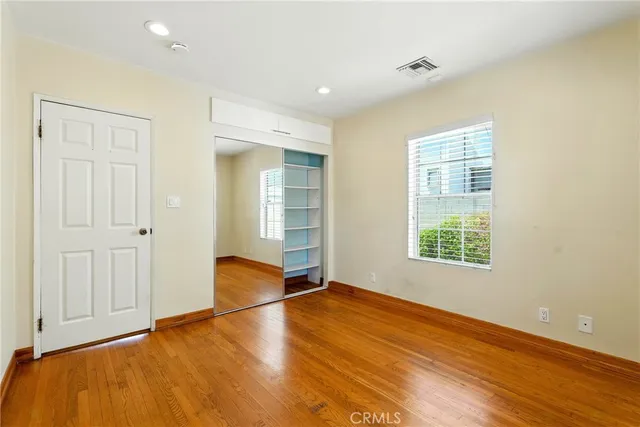 a view of room with window and wooden floor