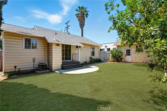 a view of a backyard with plants and a patio