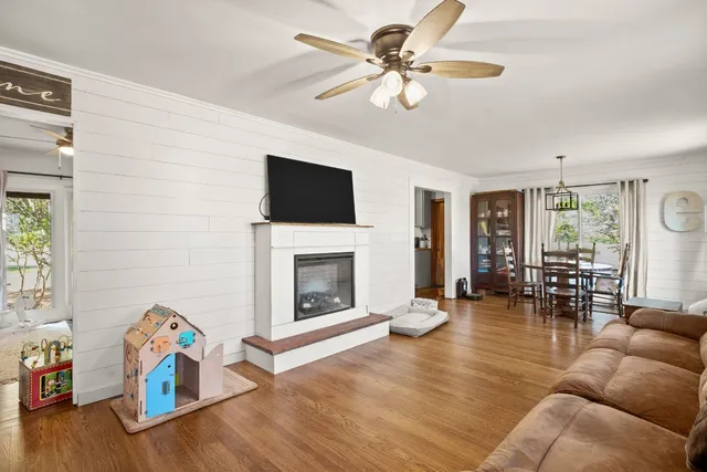 a living room with furniture a fireplace and a flat screen tv