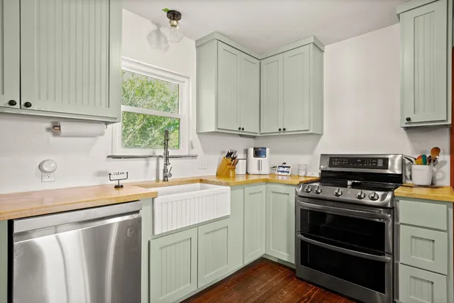 a kitchen with stainless steel appliances a refrigerator sink and microwave