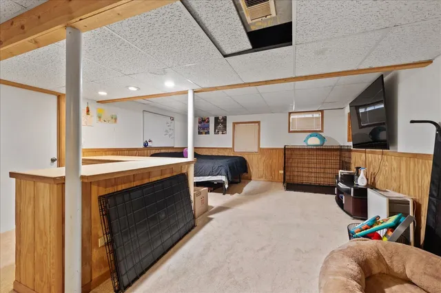 a bed room with furniture and a flat screen tv