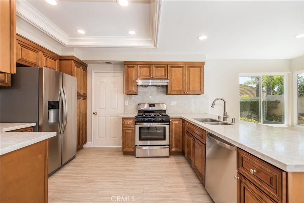 17 Palermo Irvine, CA 92614 - Photo 5 of 17 a kitchen with stainless steel appliances granite countertop a stove a sink dishwasher a refrigerator and a oven