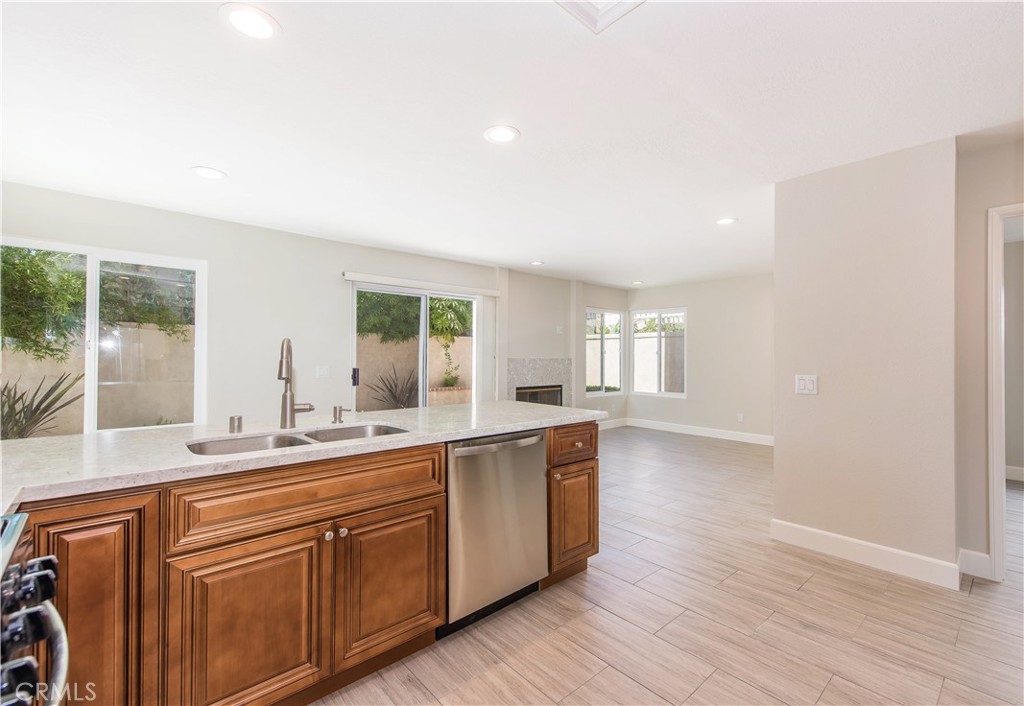 17 Palermo Irvine, CA 92614 - Photo 6 of 17 a large kitchen with stainless steel appliances a large window and wooden floor