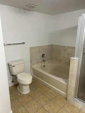 a bathroom with a toilet and a bath tub