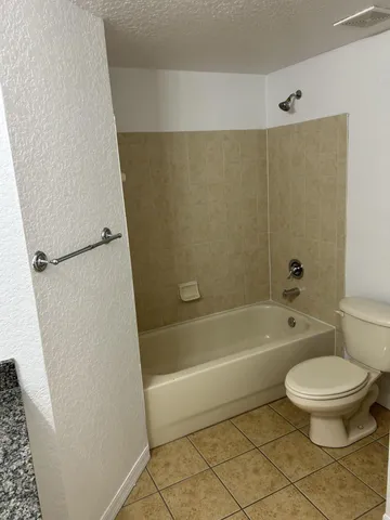 a bathroom with a toilet and a bath tub