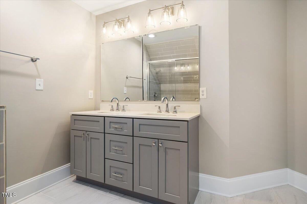 6300 Swallow Cove Lane Raleigh, NC 27614 - Photo 51 of 67 a bathroom with a sink double vanity and a mirror