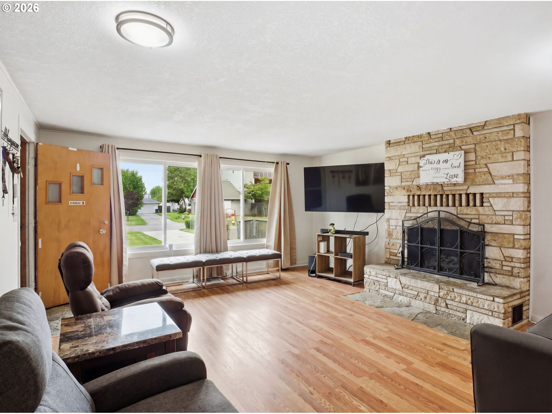 1357 Grove Street Lebanon, OR 97355 - Photo 5 of 37 a living room with furniture a fireplace and a flat screen tv