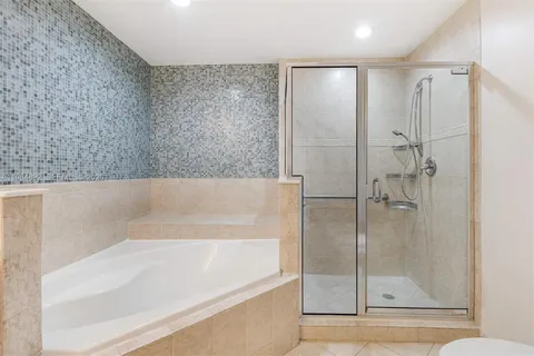 a bathroom with a bathtub and a shower