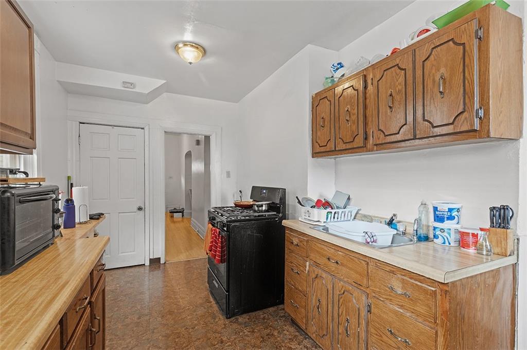3124 Universal Street Pittsburgh, PA 15204 - Photo 11 of 30 a kitchen with stainless steel appliances granite countertop a sink stove and refrigerator