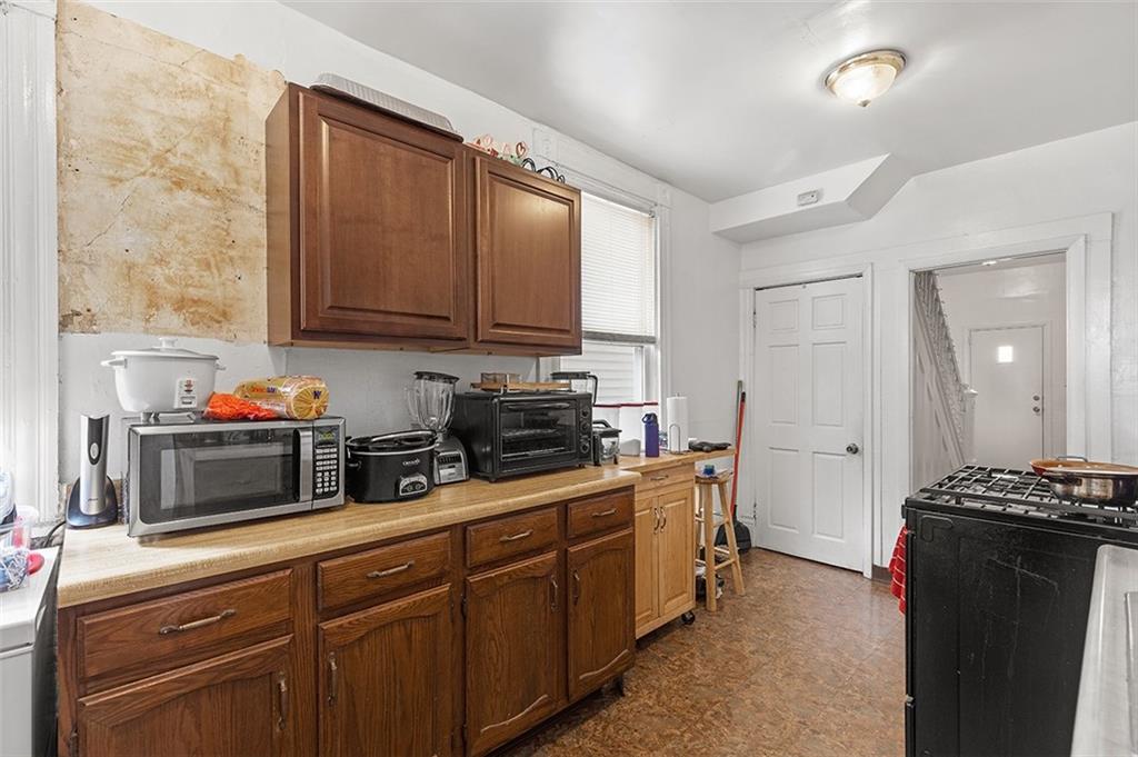 3124 Universal Street Pittsburgh, PA 15204 - Photo 12 of 30 a kitchen with stainless steel appliances granite countertop a stove a sink and a microwave