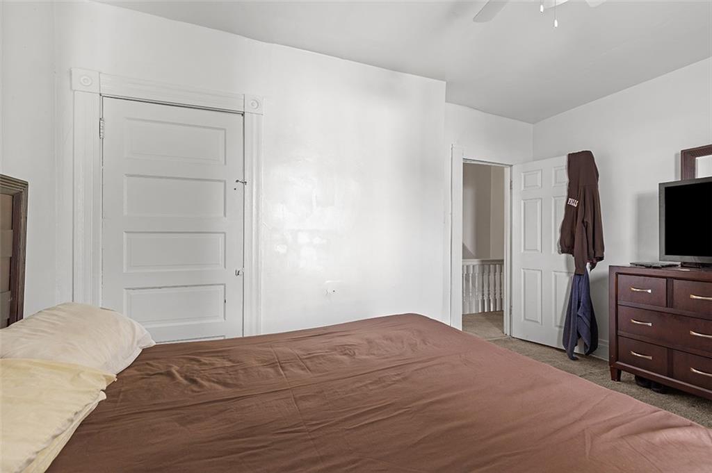 3124 Universal Street Pittsburgh, PA 15204 - Photo 22 of 30 a bedroom with a bed and flat screen tv