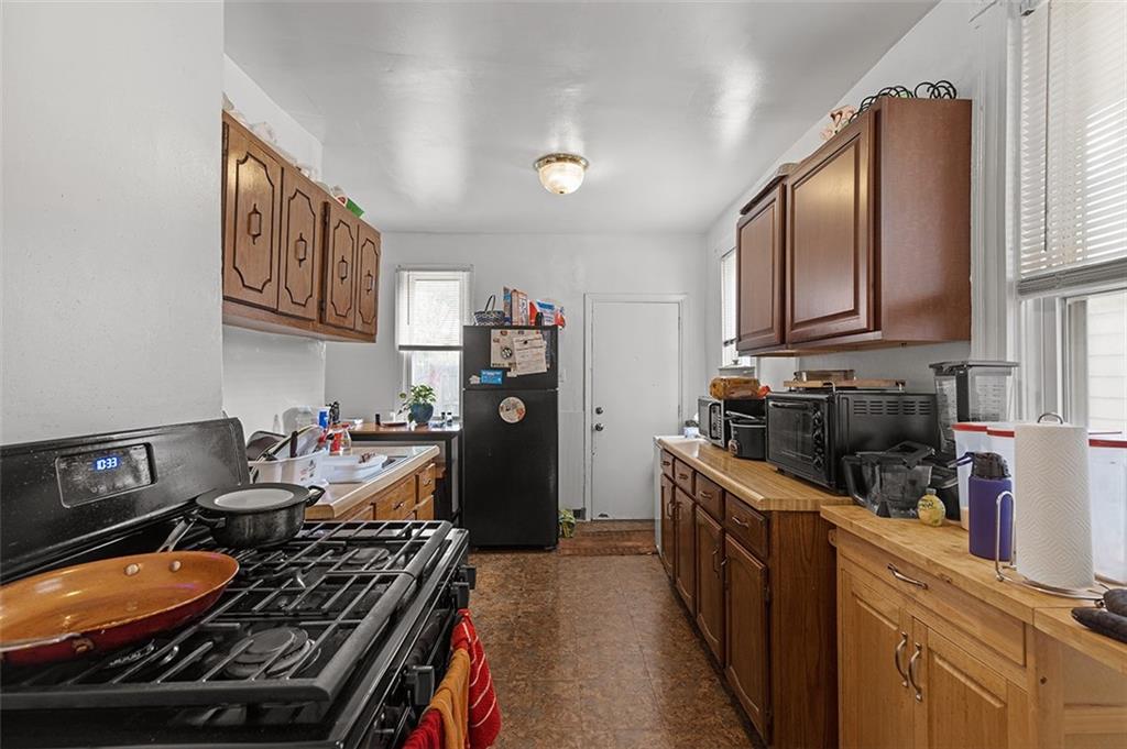 3124 Universal Street Pittsburgh, PA 15204 - Photo 8 of 30 a kitchen with blue cabinets stove top oven and sink