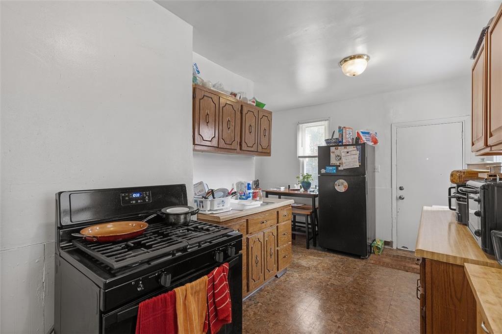 3124 Universal Street Pittsburgh, PA 15204 - Photo 9 of 30 a kitchen with a stove and a refrigerator