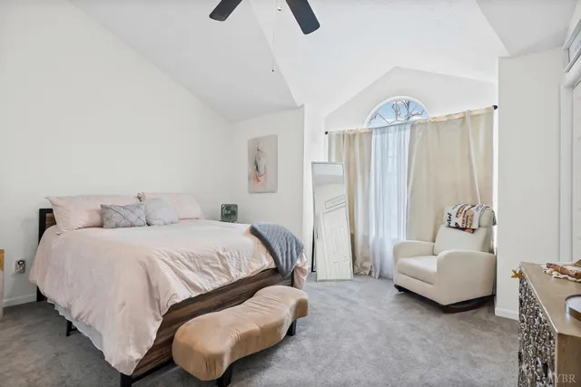 a spacious bedroom with a bed and a couch