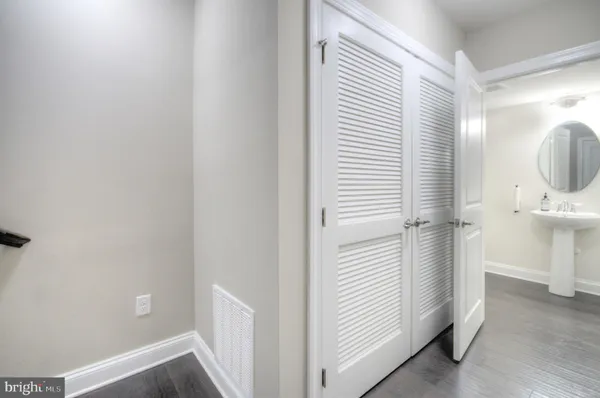 a view of entryway and hall with wooden floor