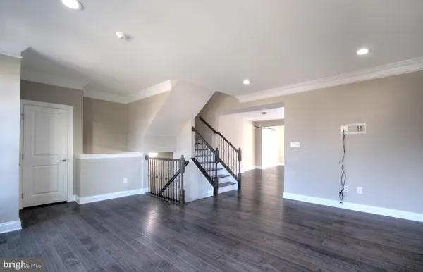 a view of entryway with wooden floor and stairs