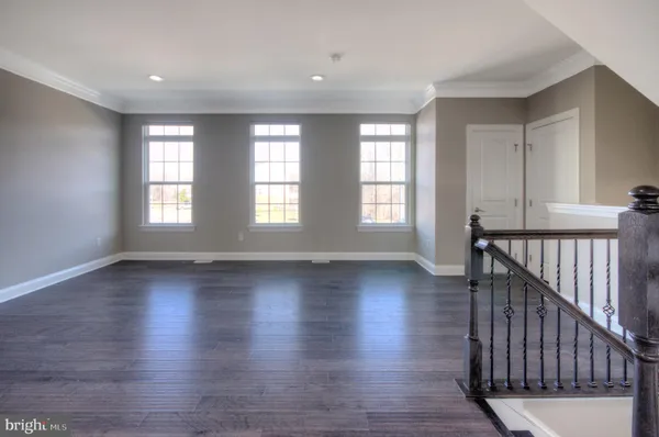 a large kitchen with stainless steel appliances granite countertop a stove and a wooden floors