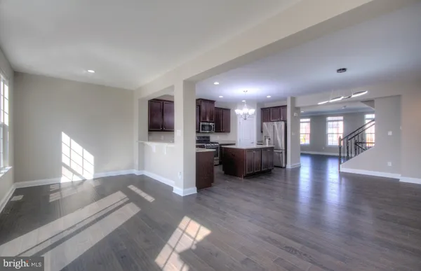 a view of a kitchen with a refrigerator and a microwave