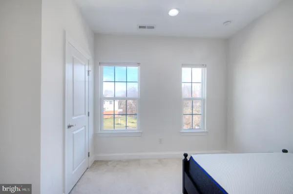 a spacious bathroom with a double vanity sink and a mirror