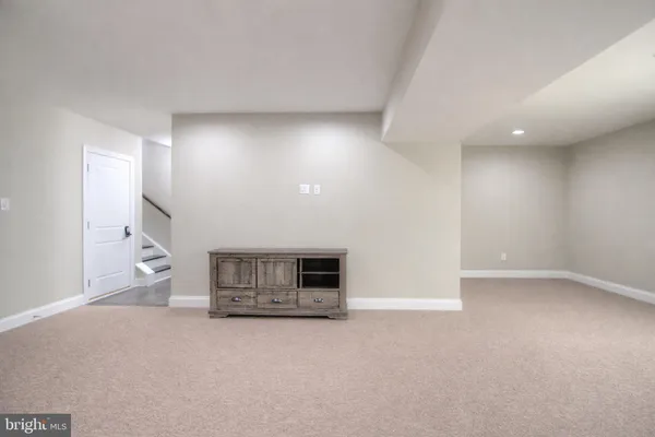 an empty room with a fireplace and windows