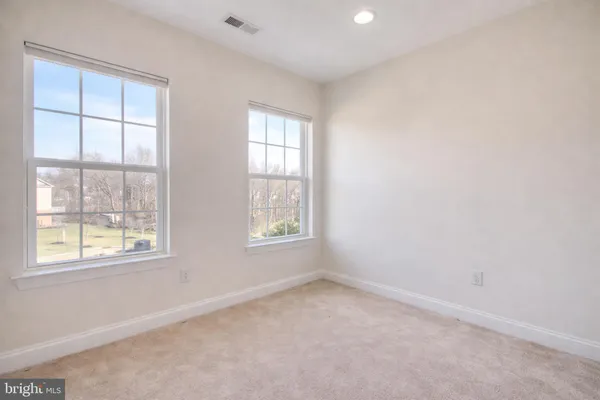 a view of an empty room with a ceiling fan