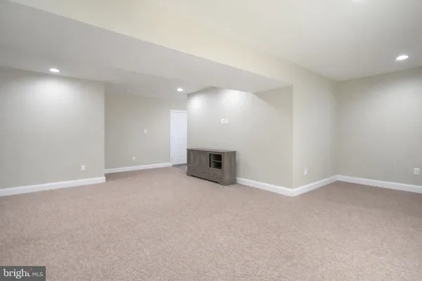a view of an empty room and a fireplace