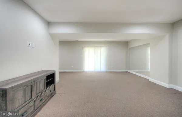 a view of hallway with wooden floor