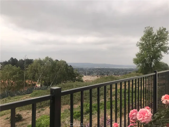 a balcony with wooden floor and city view