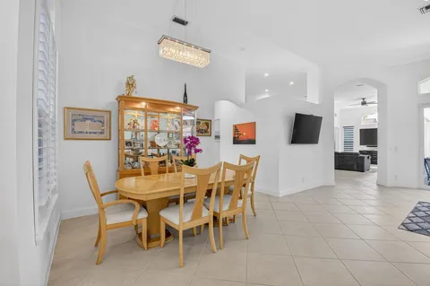 a view of a dining room with furniture and kitchen view